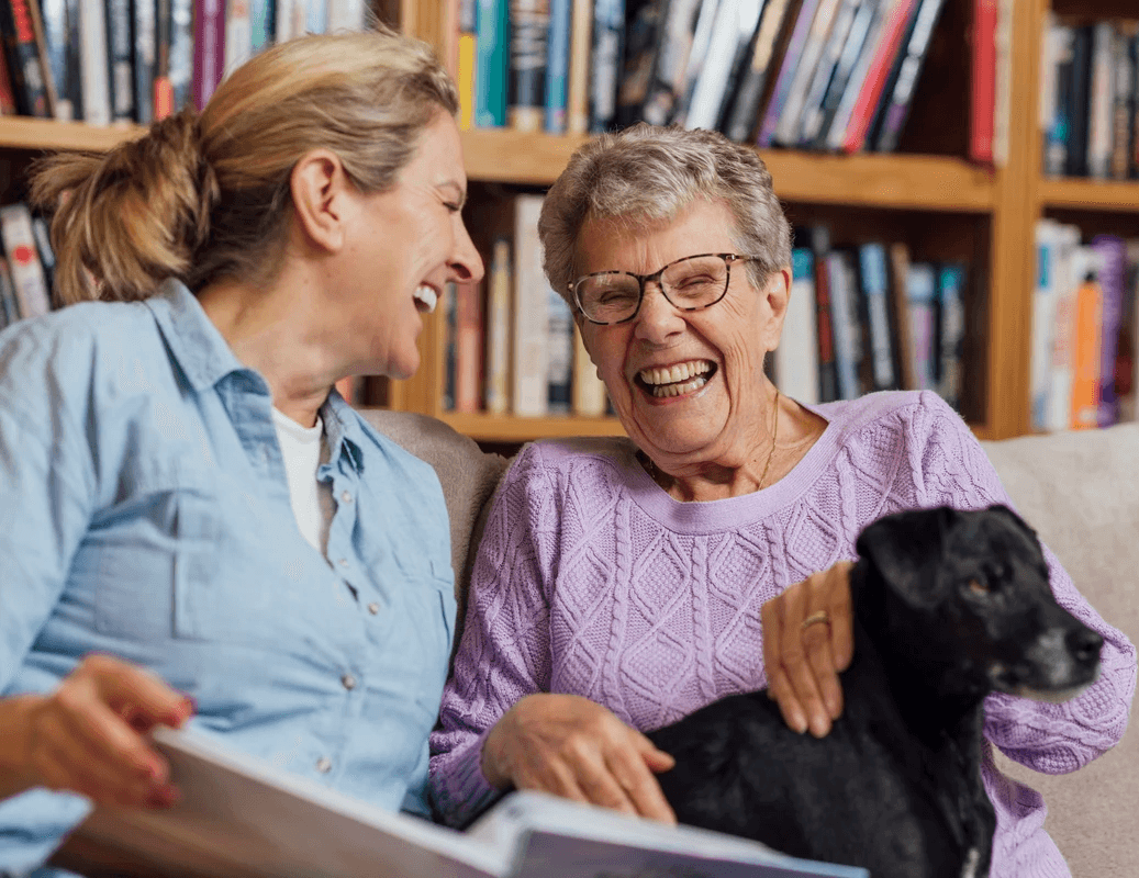 Memory care resident and social worker with therapy dog