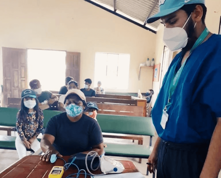 a man is giving a child something to eat