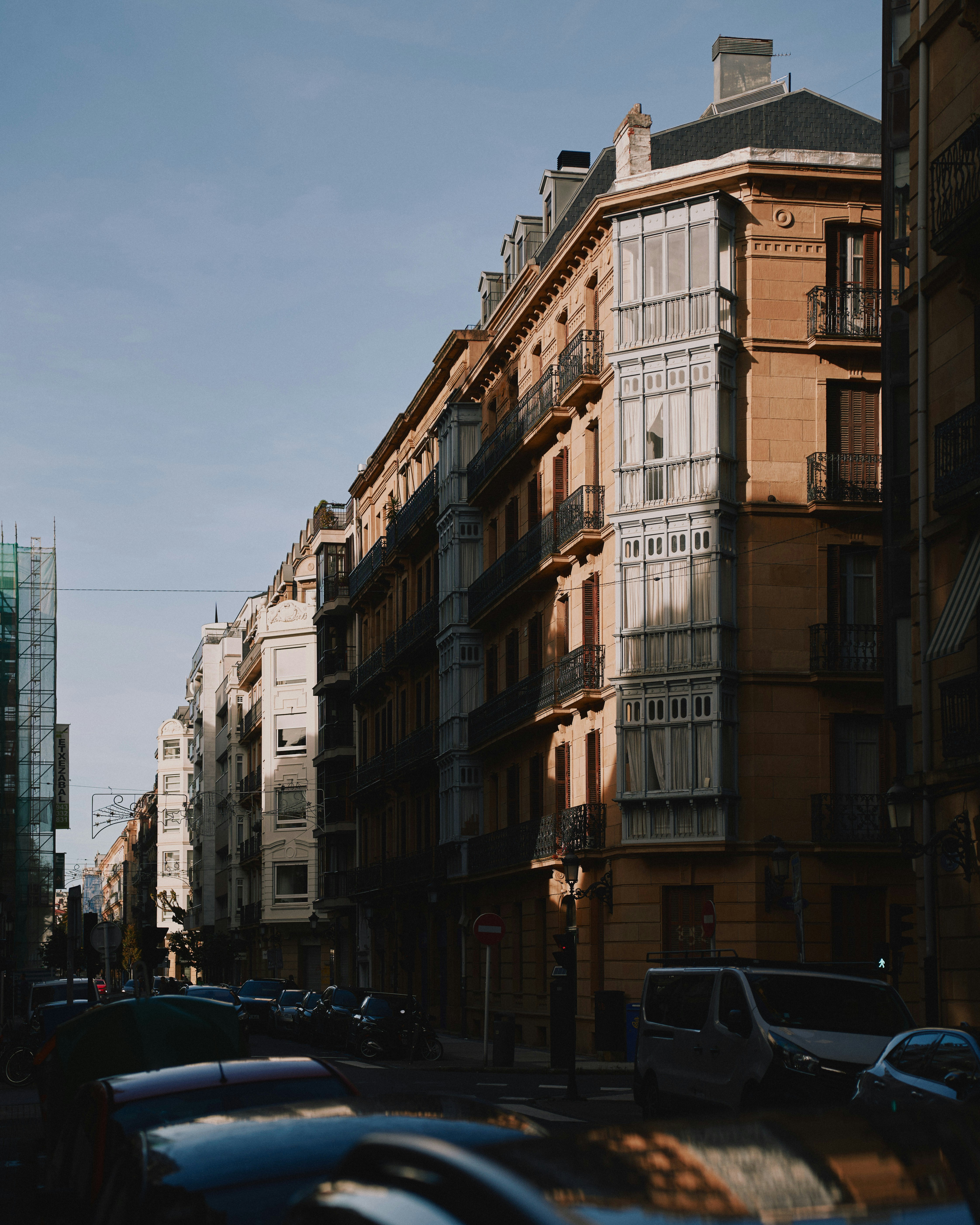 Sunlight illuminates buildings on a city street.