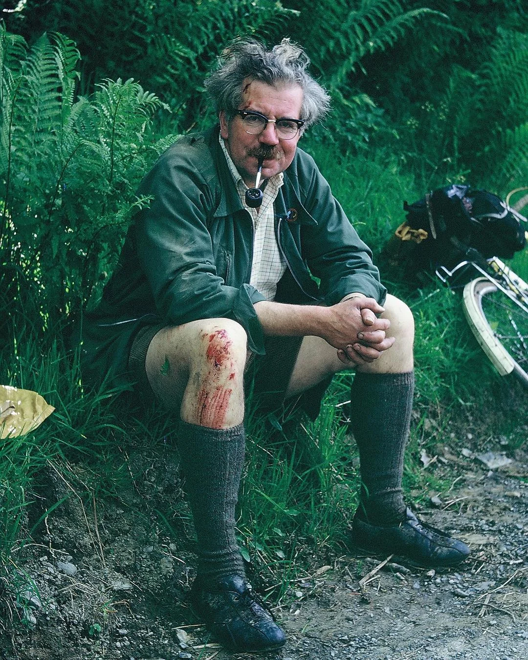 Man sitting outdoors smoking a pipe