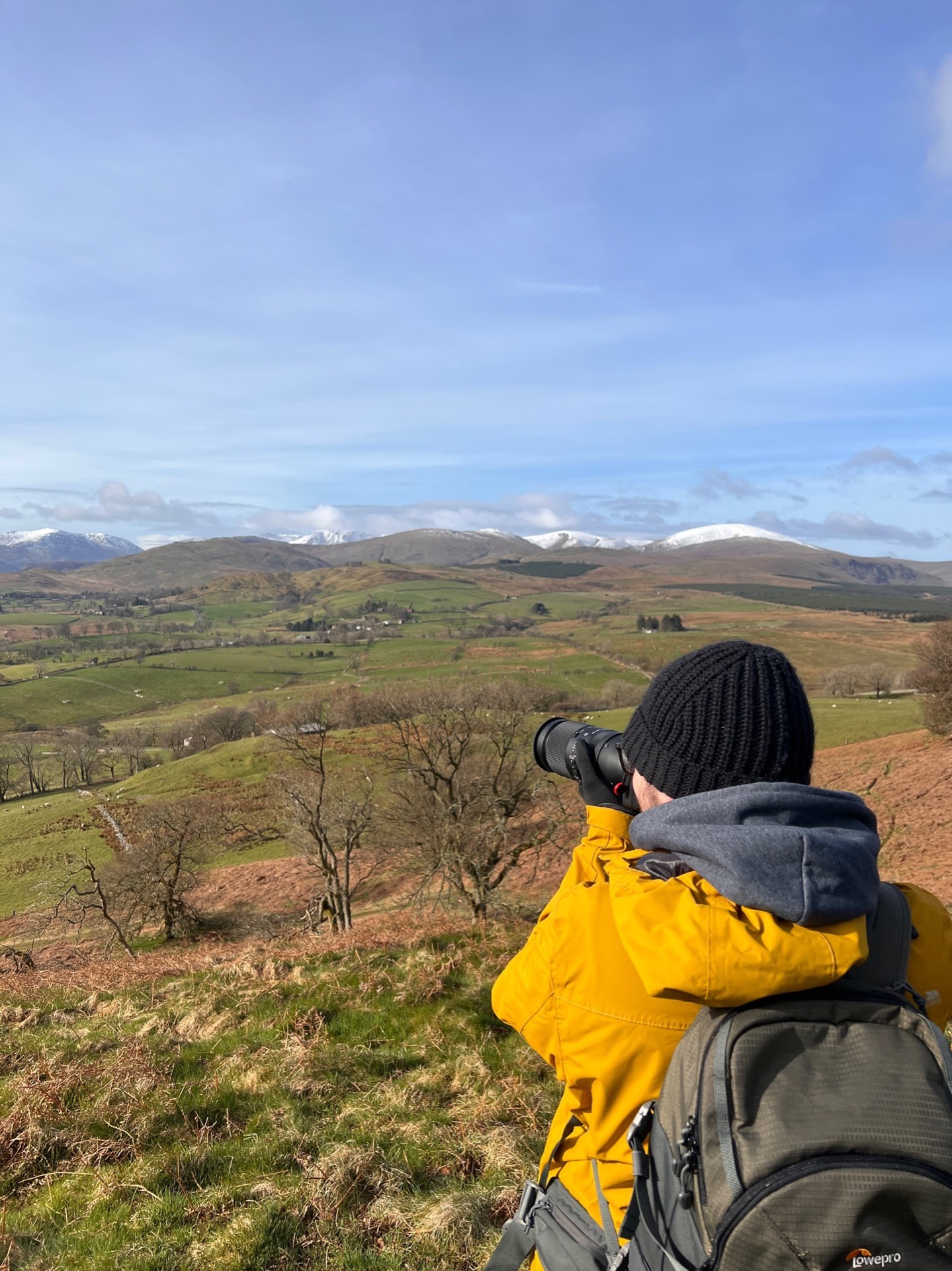 Martin with his camera taking a photo into the distance.