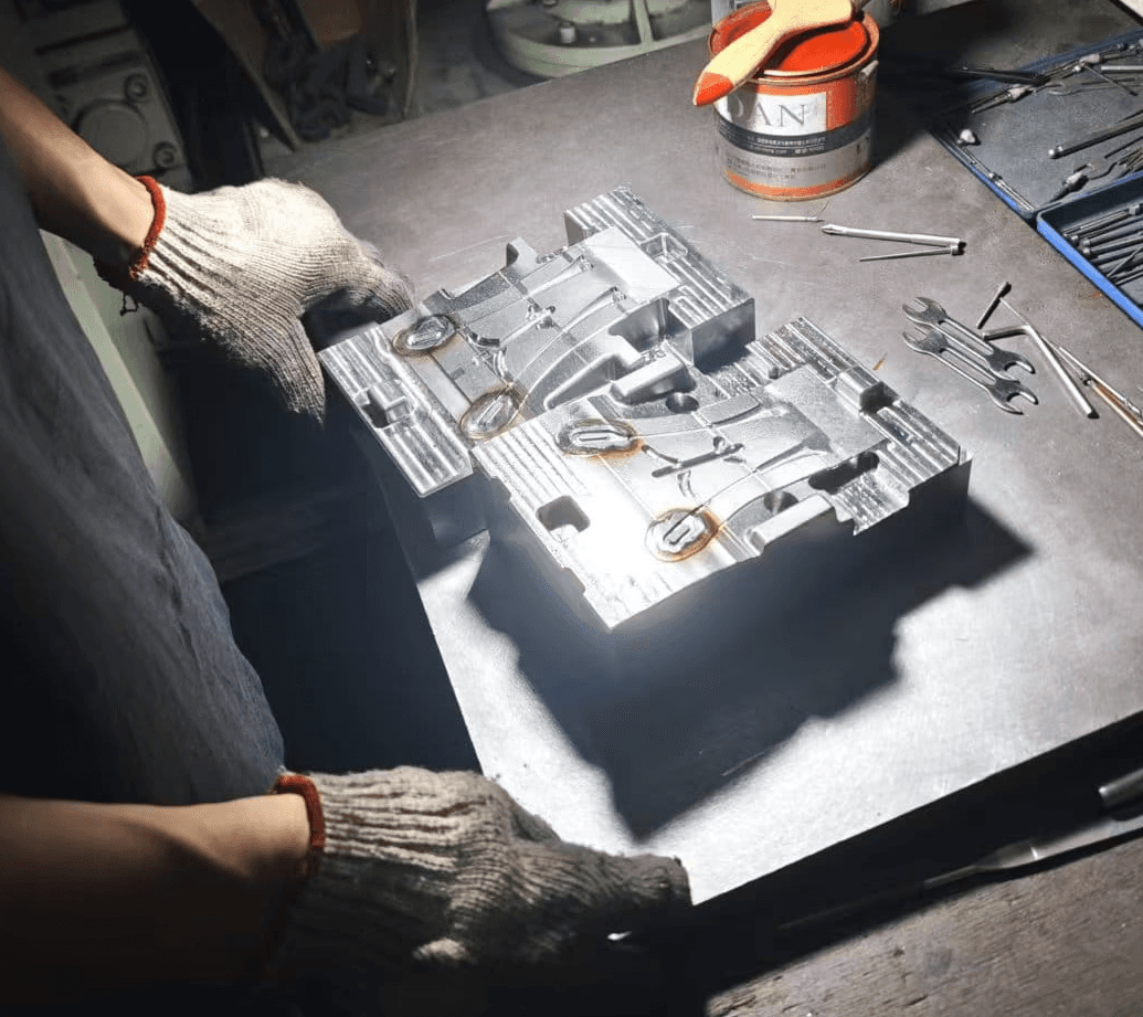 Metal production tooling being inspected on a manufacturing workbench