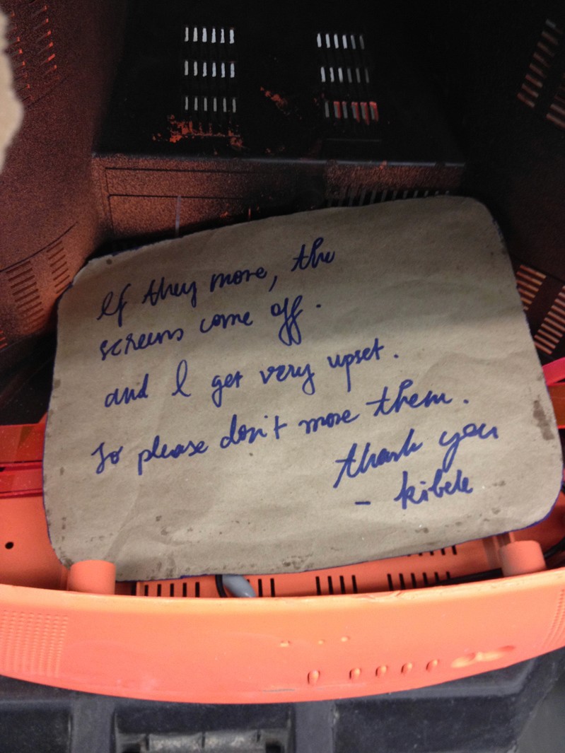 a message on ca cardboard with the message If they move, the scrum come off and I get very upset. So please don't move them. Thank you - Kible