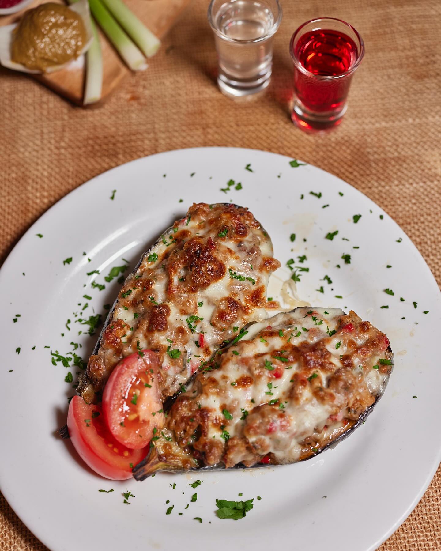 Cheesy, golden-baked stuffed potatoes topped with savory meat and herbs—one of the signature Eastern European comfort dishes at Loft by Hot Potato in Brooklyn. A must-try for fans of hearty, home-cooked flavors!