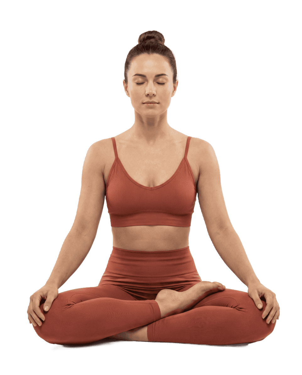 A woman sits cross-legged with eyes closed, wearing a white blouse and a long purple skirt, looking serene. (Background Removed)