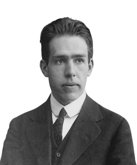 A black-and-white portrait of Niels Bohr, the influential Danish physicist known for his contributions to atomic theory and quantum mechanics, wearing a formal suit and tie. His youthful face reflects a calm and thoughtful expression, capturing the early years of his groundbreaking scientific career.