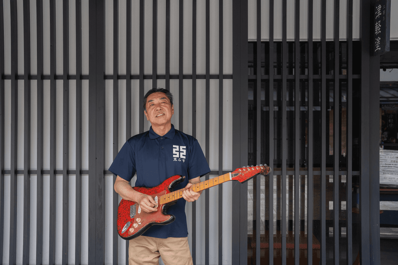 Mr. Kudō with his handmade lacquerware electric guitar