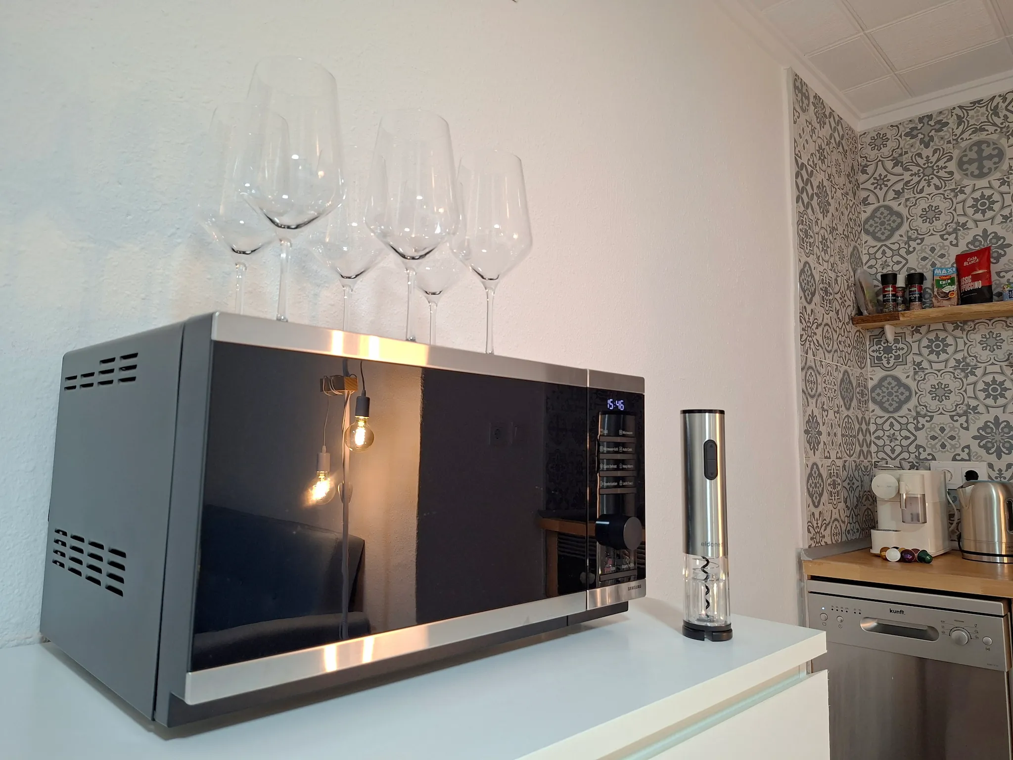 Minimalist living space with low modern furniture, large floor-to-ceiling windows, soft natural light, and an open view of a calm outdoor landscape.