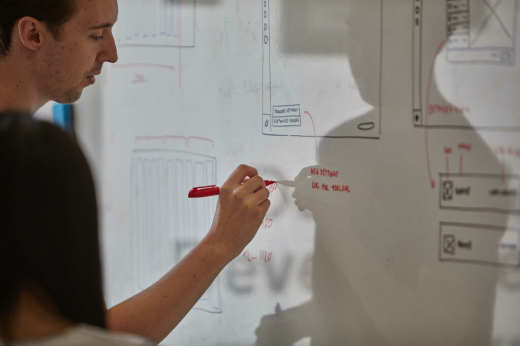 Working on UI wireframes at the whiteboard