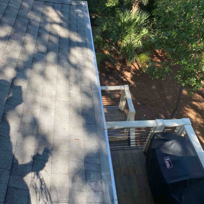 Before and after—gutter cleaned in Hilton Head SC, clear water flow restored after debris removal.