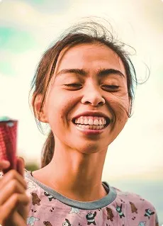 a young woman smiling showing teeth