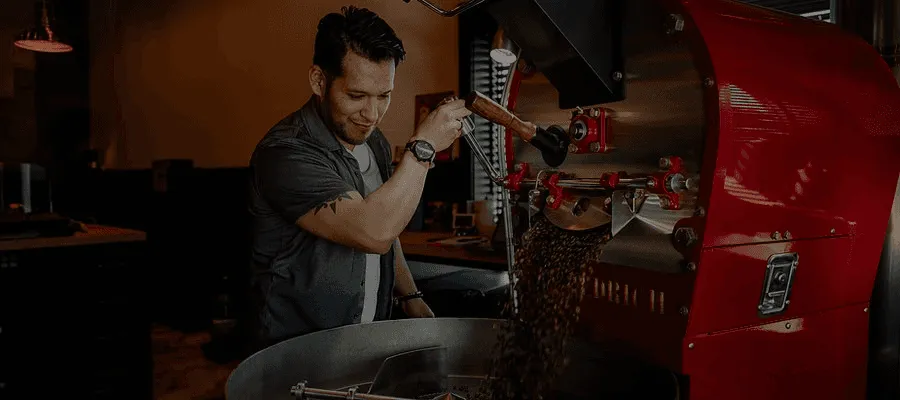 Barista at Pain d'Avignon roastery preparing small-batch coffee