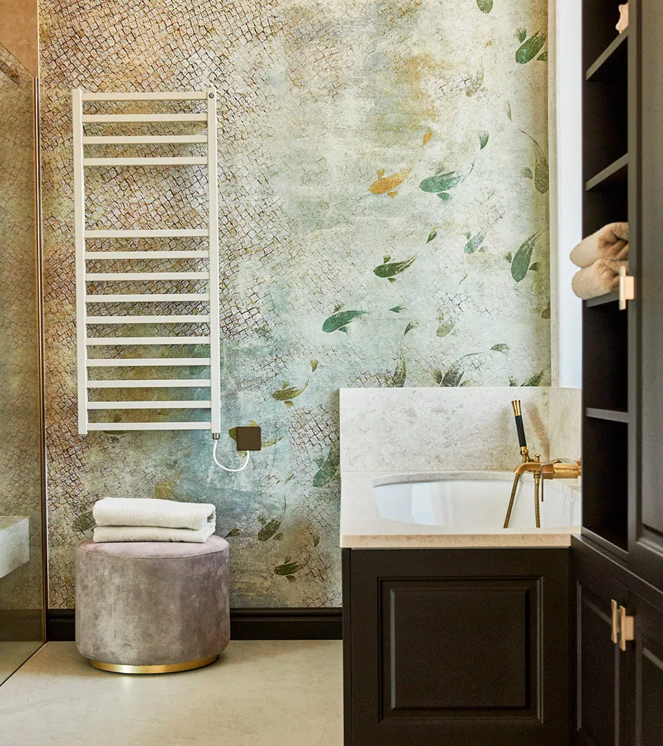 Villa Belmare bathroom detail with patterned feature wall, towel radiator, and modern vanity
