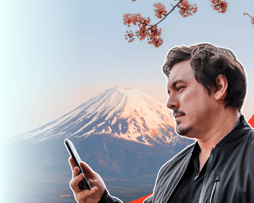 Chris Broad using his phone with eSIM active near Mount Fuji, symbolizing reliable eSIM connectivity for travelers in Japan.