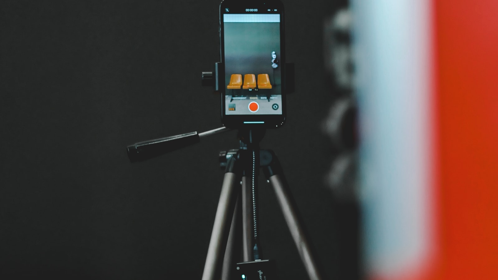 A smartphone on a tripod recording a student testimonial video