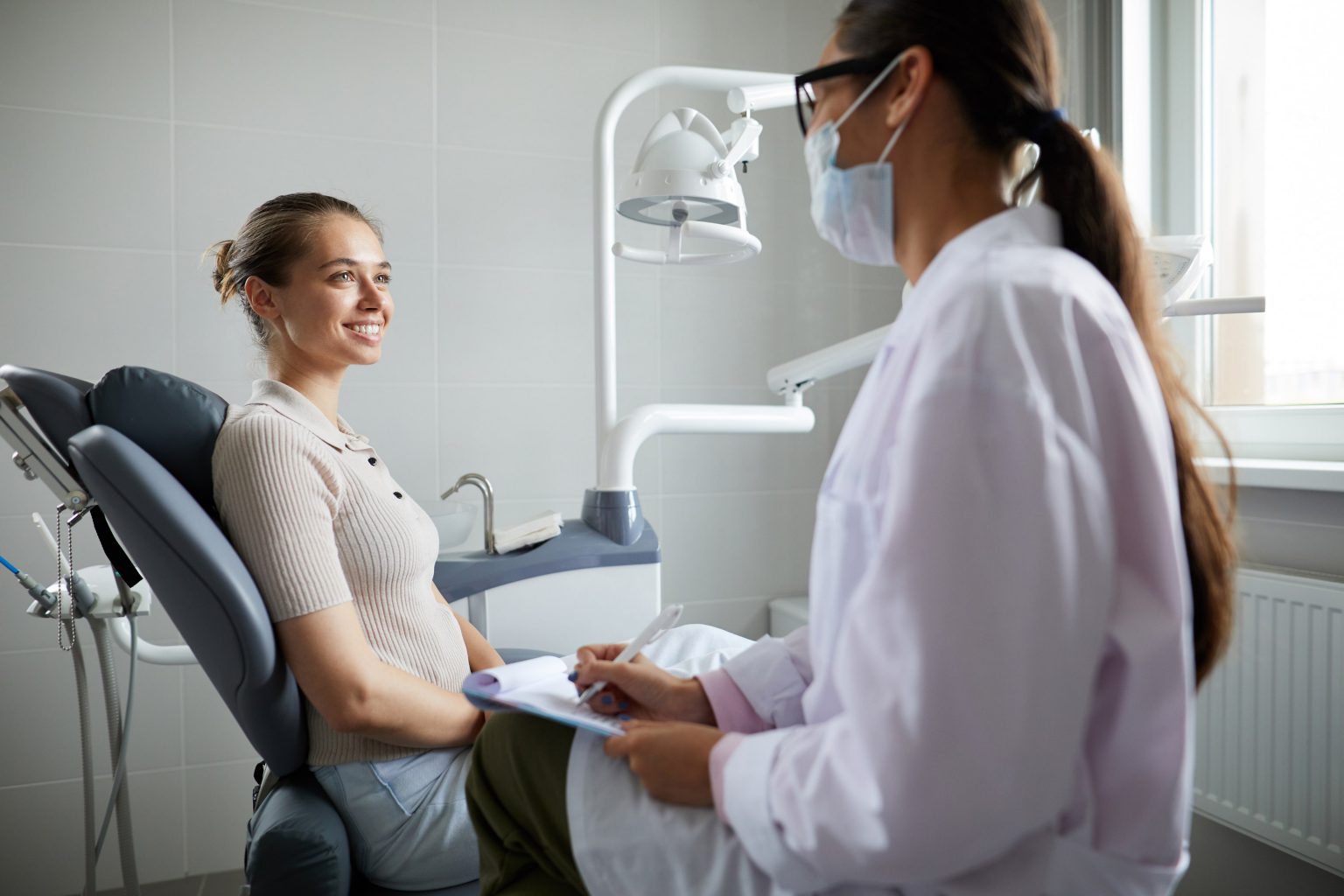 Dentist talking to patient on chair