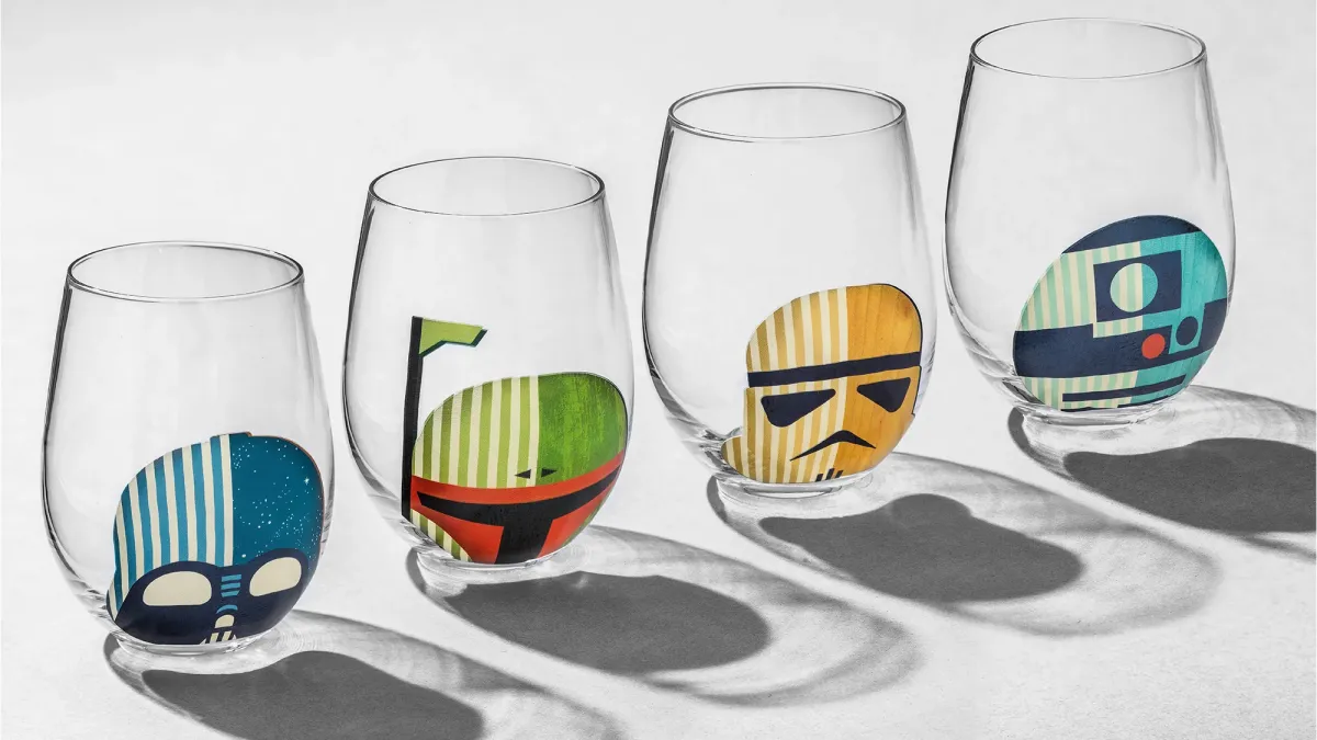 A set of 4 Star Wars JoyJolt glassess with minimalist designs of Darth Vader, Boba Fett, a Stormtrooper, and R2-D2