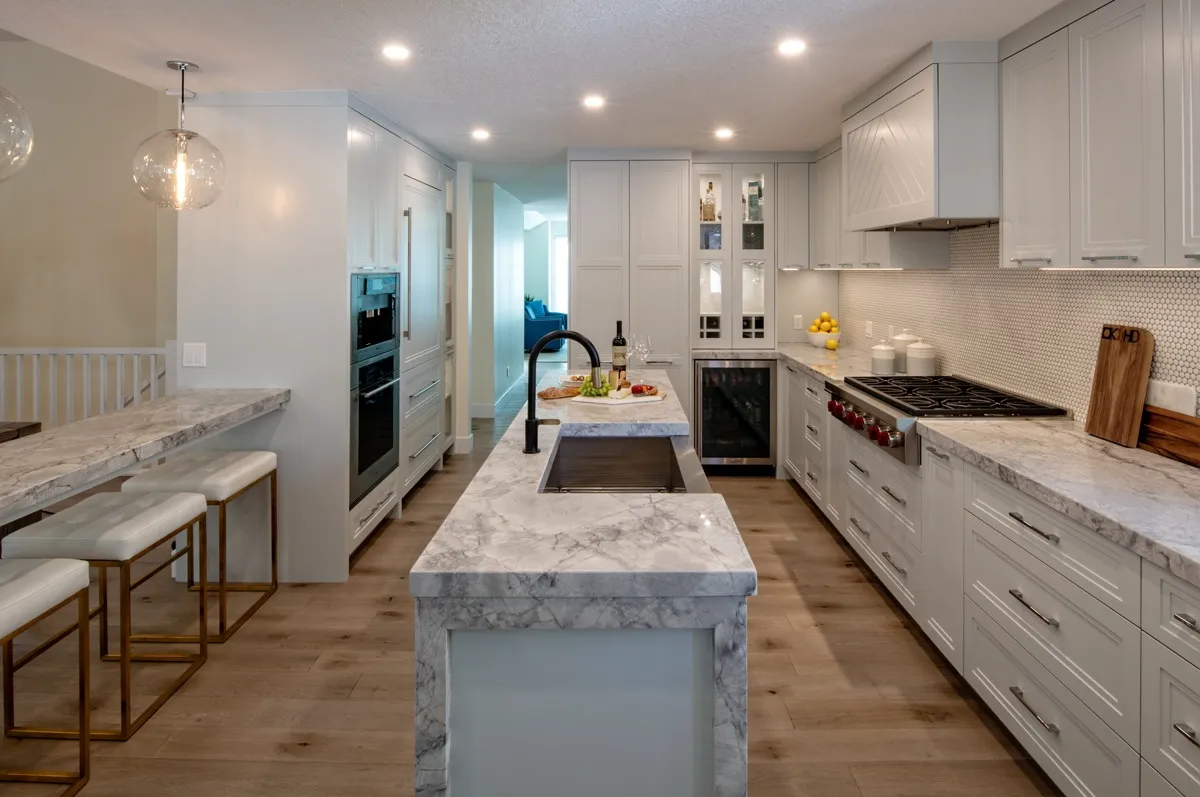Image of Modern kitchen design with marble countertops, white cabinets, and layout design by KHD Homes.