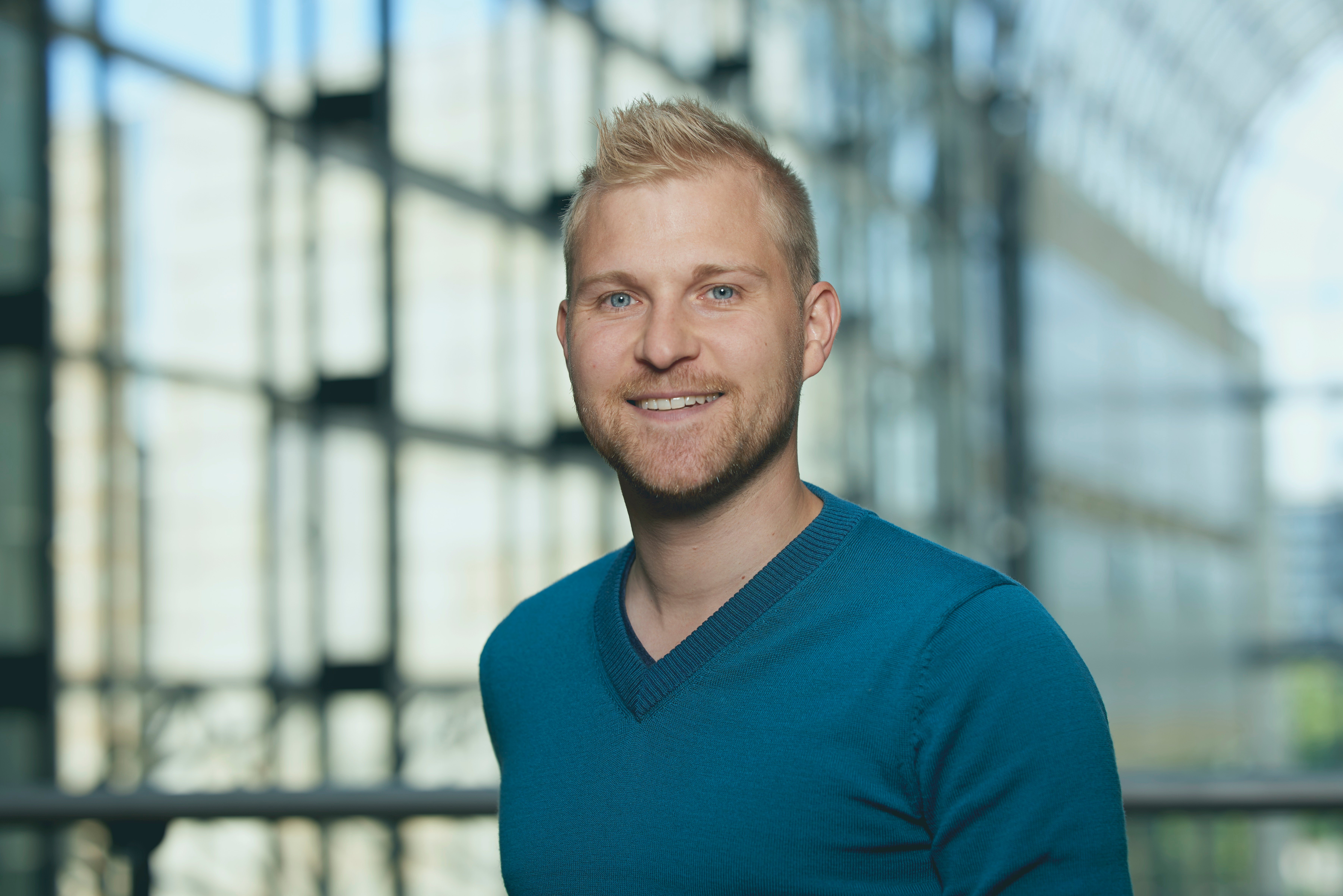 Portrait photo of a man in a blue sweater