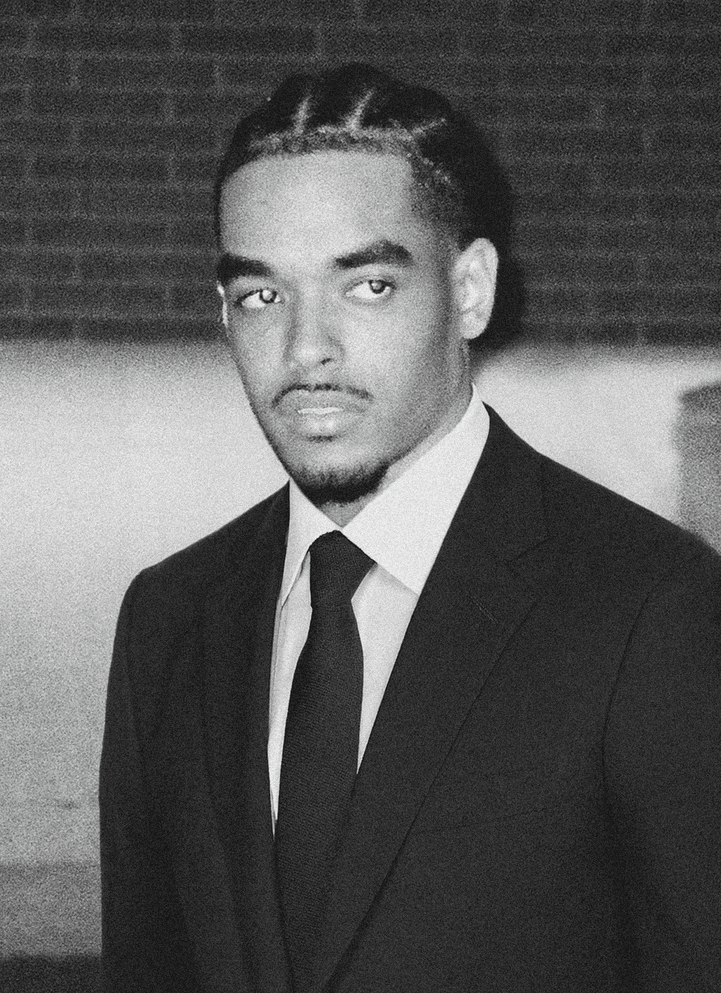 Black and white portrait of a smiling person with curly hair
