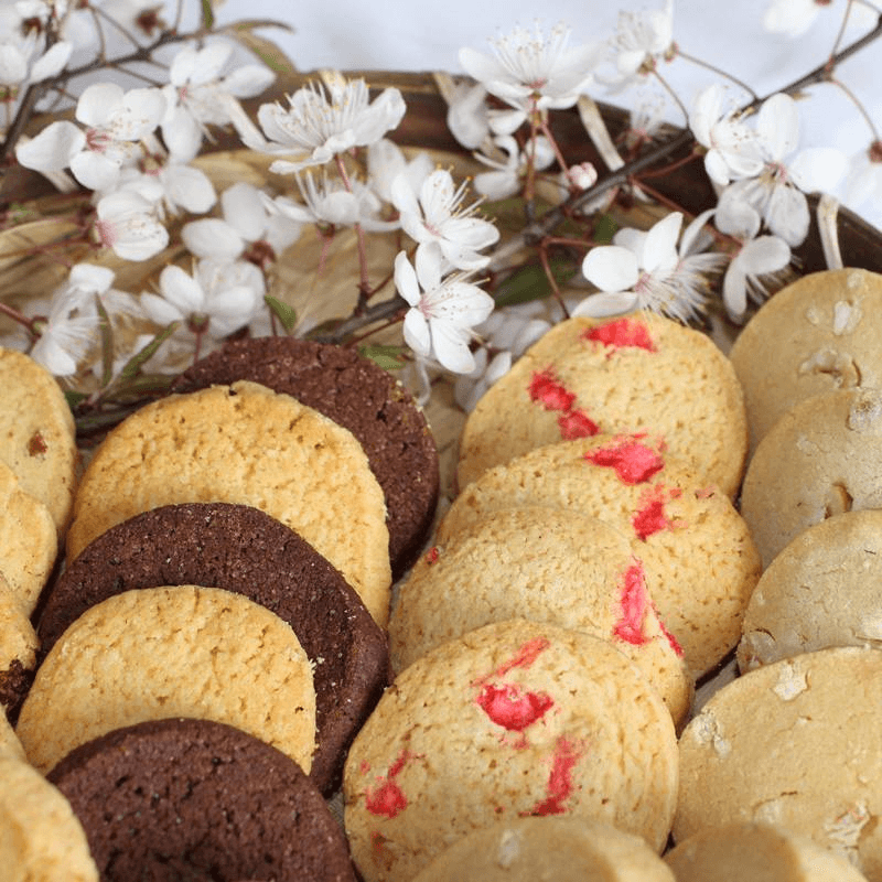 a table topped with white plates filled with slices of cake