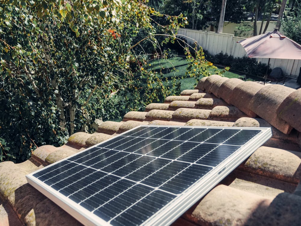 Free Close-up of a solar panel installed on a tiled roof, capturing clean energy. Stock Photo