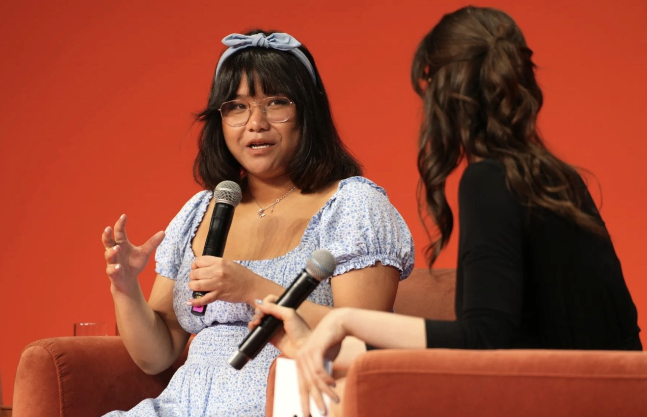 Four people sitting on a couch and smiling