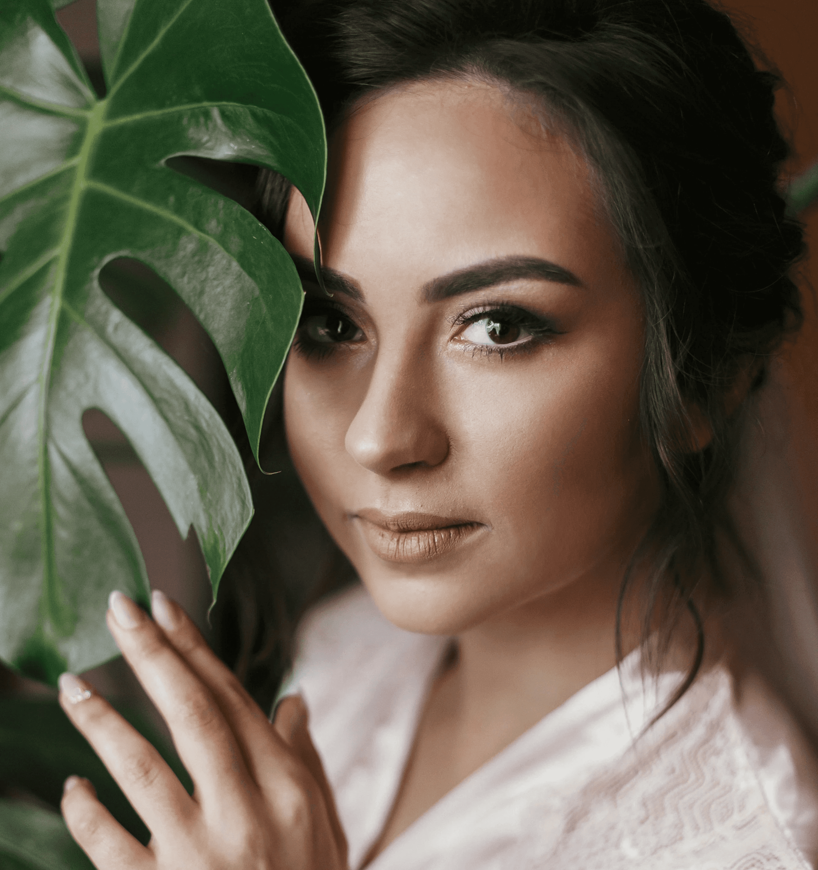 Face closeup with Monstera leaf