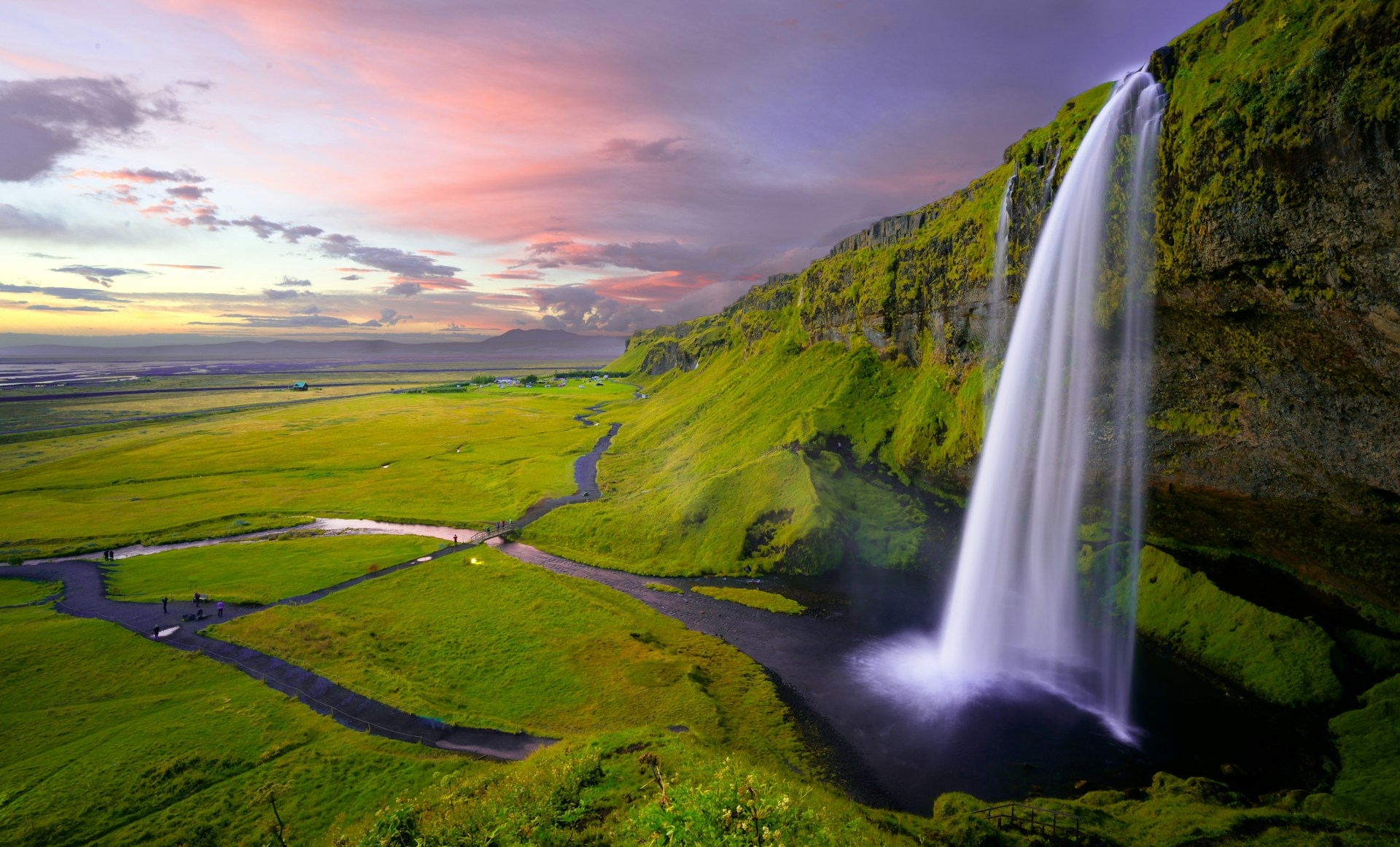 Seljalandsfoss waterfall at sunset in South Iceland.