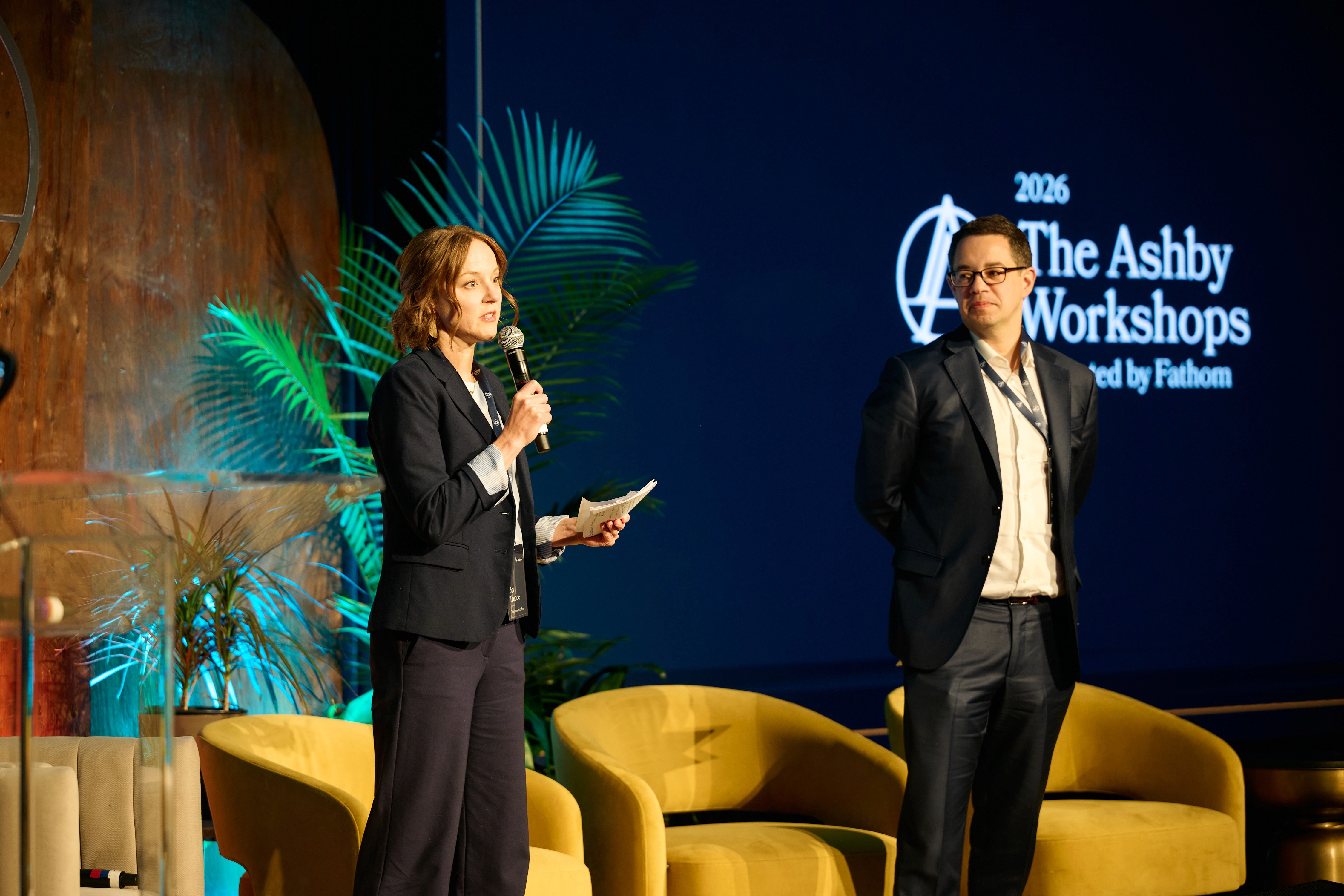 man in gray dress shirt holding black camera