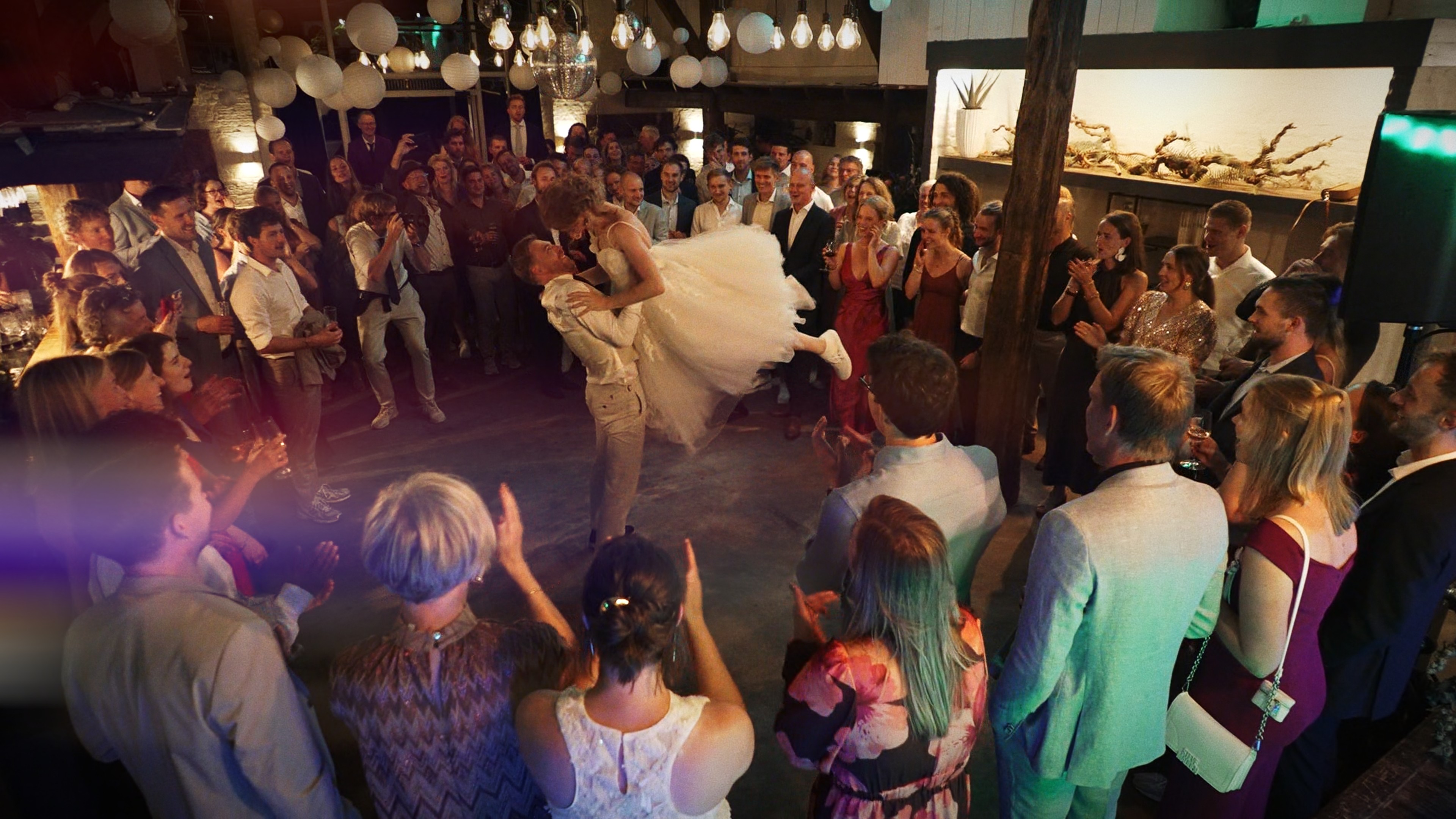 A ballerina with long hair throws her arms up
