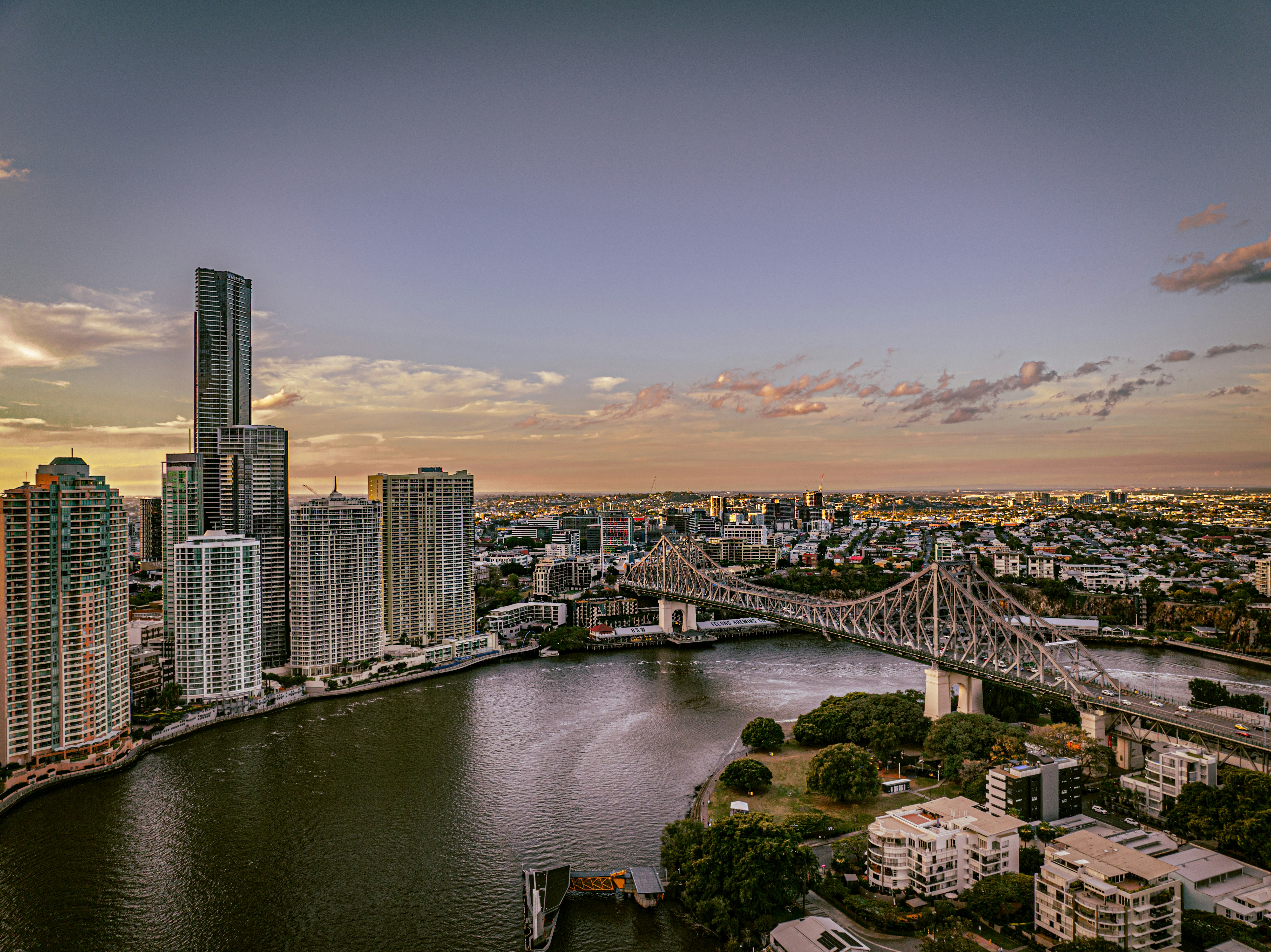 a bridge over a river with a city in the background