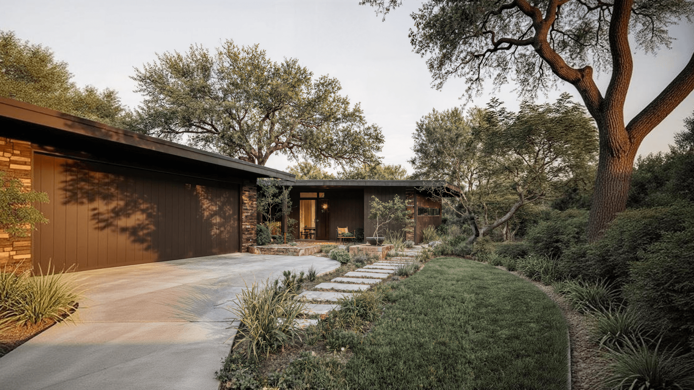 Modern architecture blends with nature in a landscaped garden, featuring a pathway and trees.