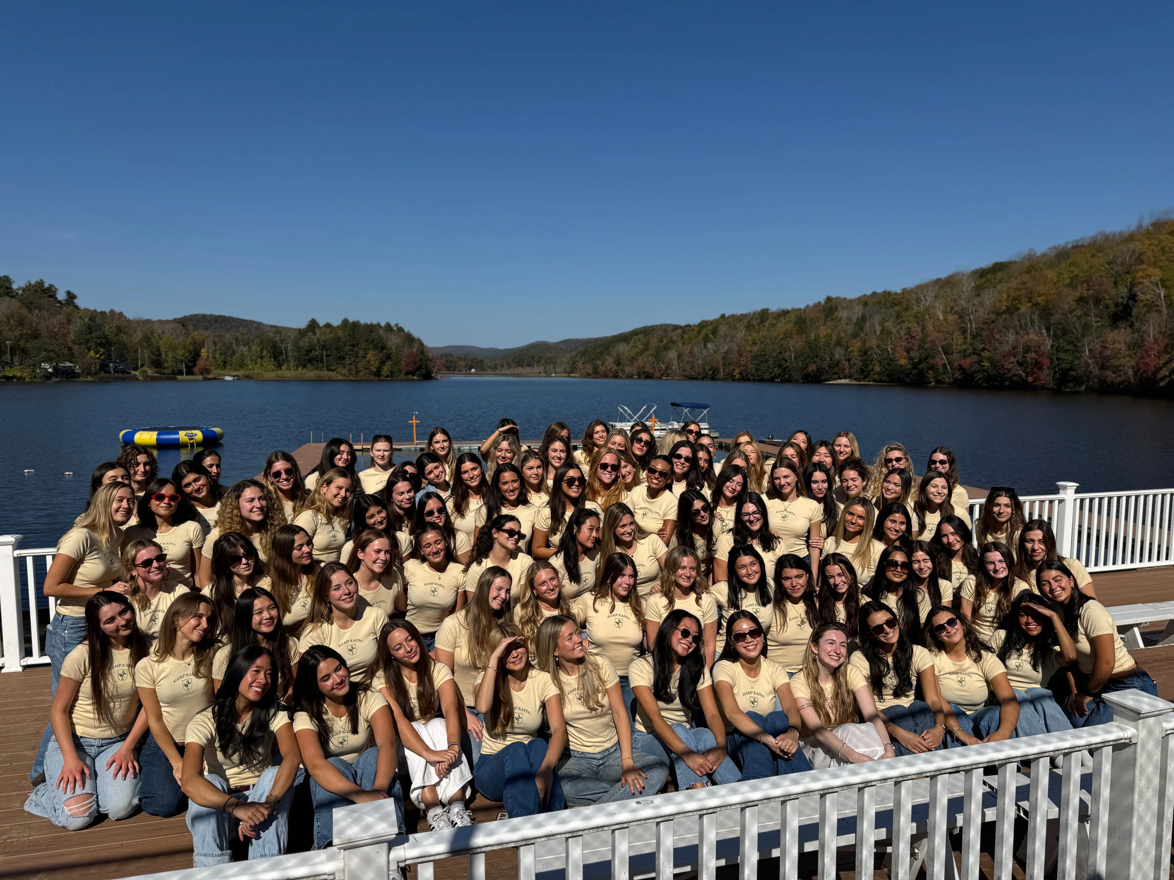 Large retreat group posing by the lake at Camp Lenox