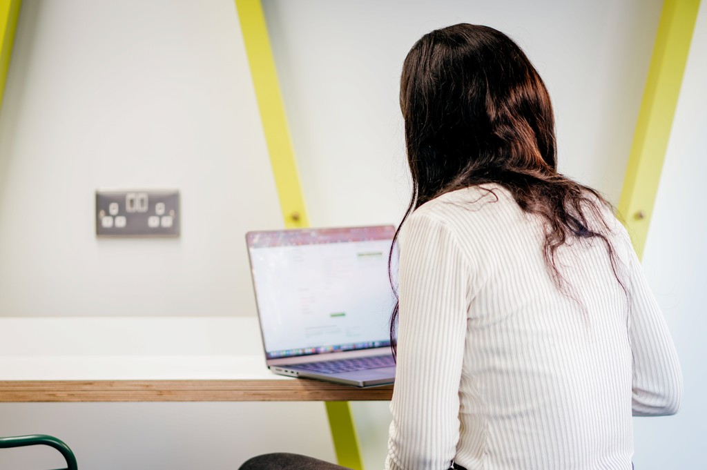 Opencast team member working at a computer in an office space