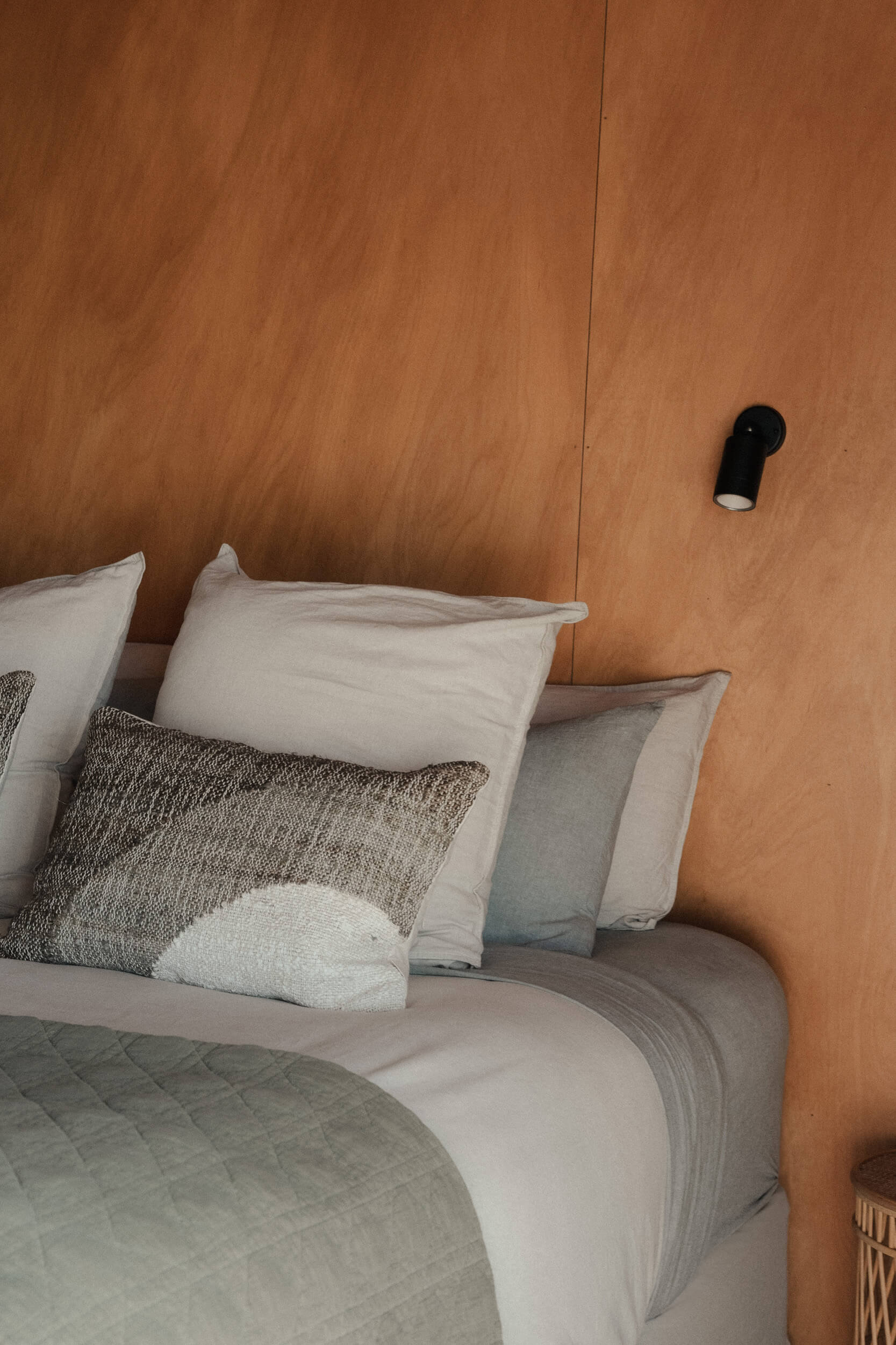 Natural materials and soft light in the bedroom at ITI, Raglan