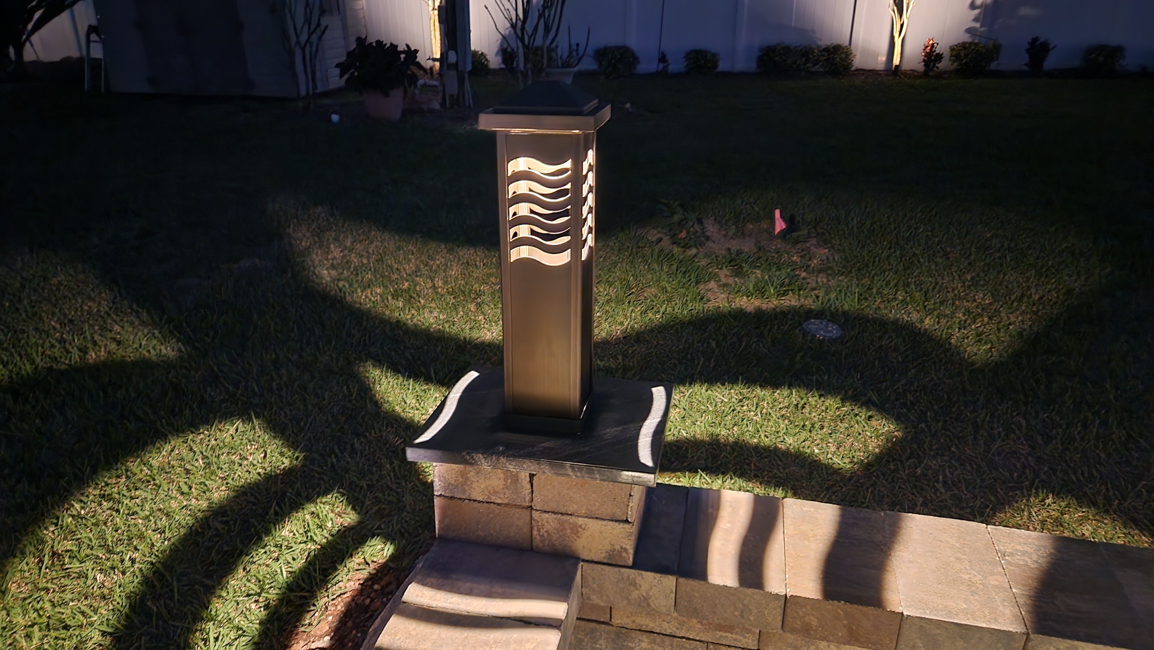 Modern pathway and patio lighting installed along outdoor seating and garden areas