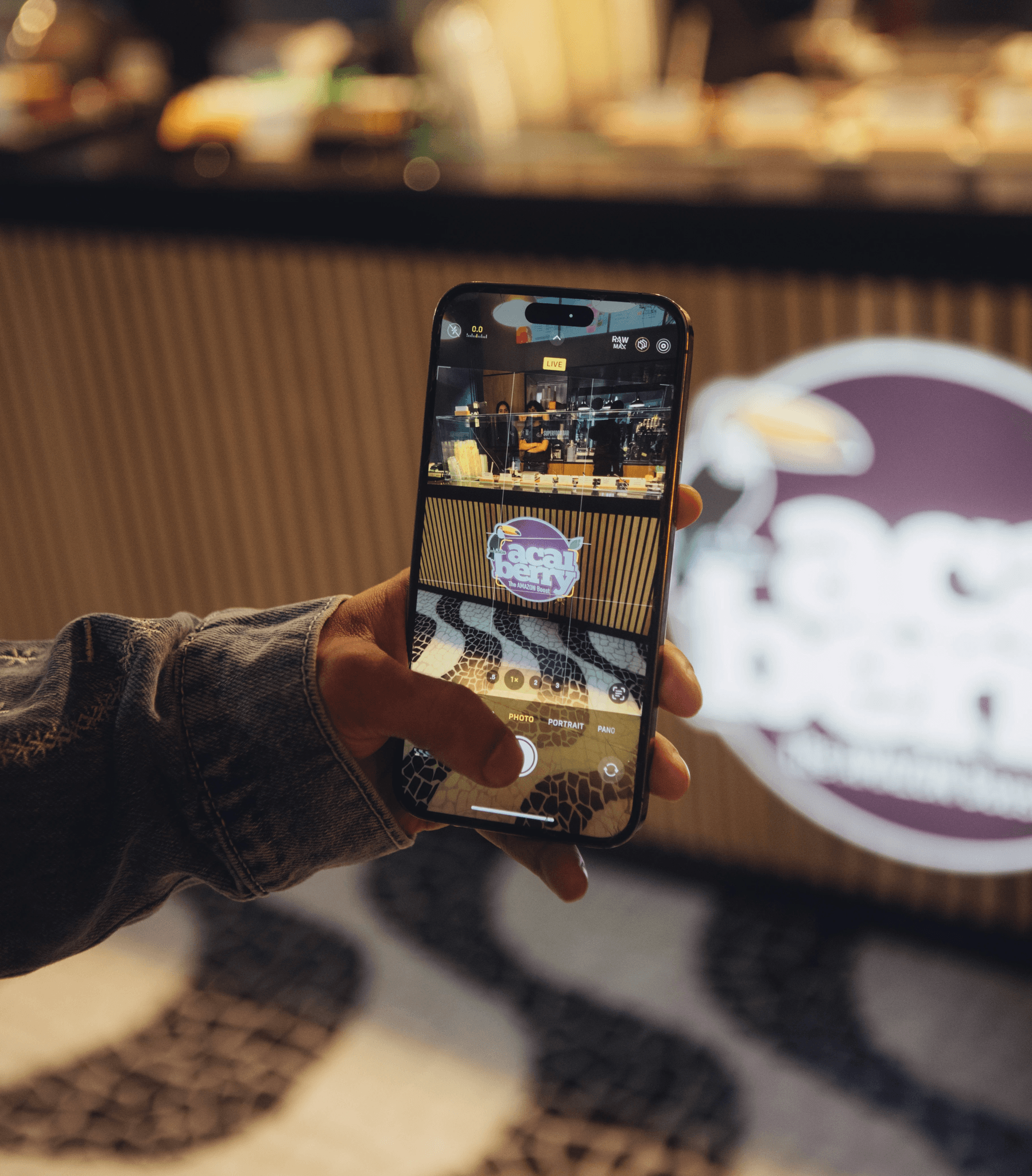 A crowd of people gathered outside an Açaí Berry store on a sunny day, wearing athletic clothing and running gear, participating in an Açaí Berry Run Club event.