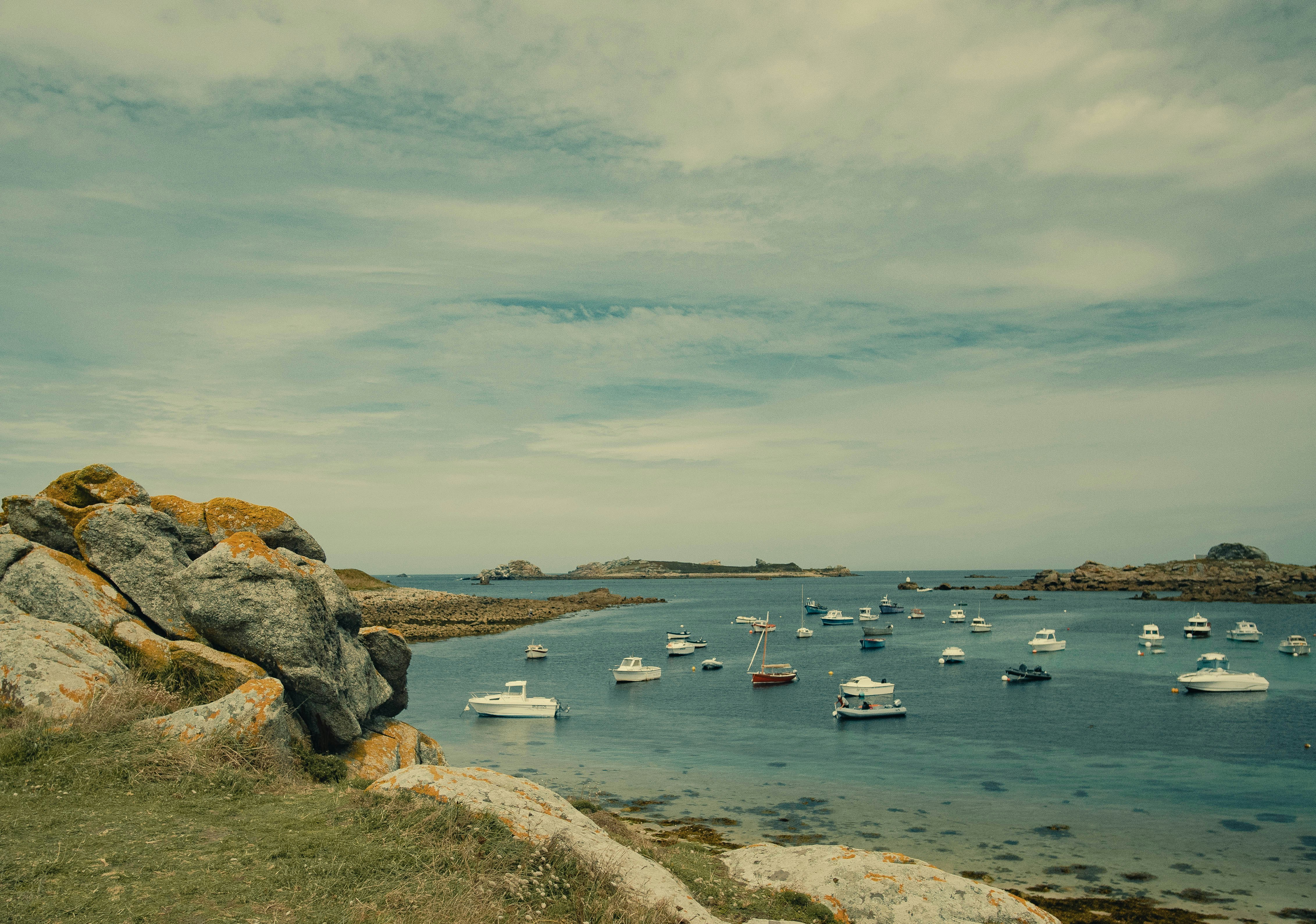 a group of boats floating on top of a body of water