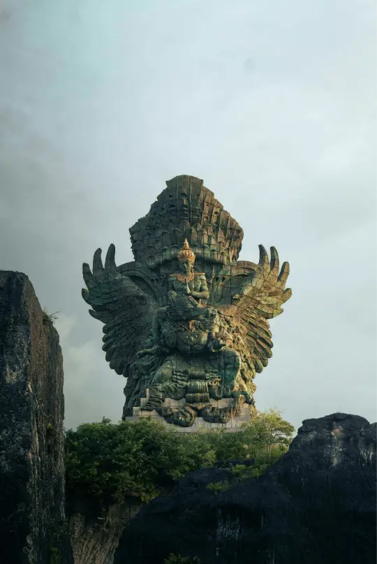 Close-up of the Garuda Wisnu Kencana cultural monument in Bali, featuring intricate green-patina details of Vishnu and Garuda.