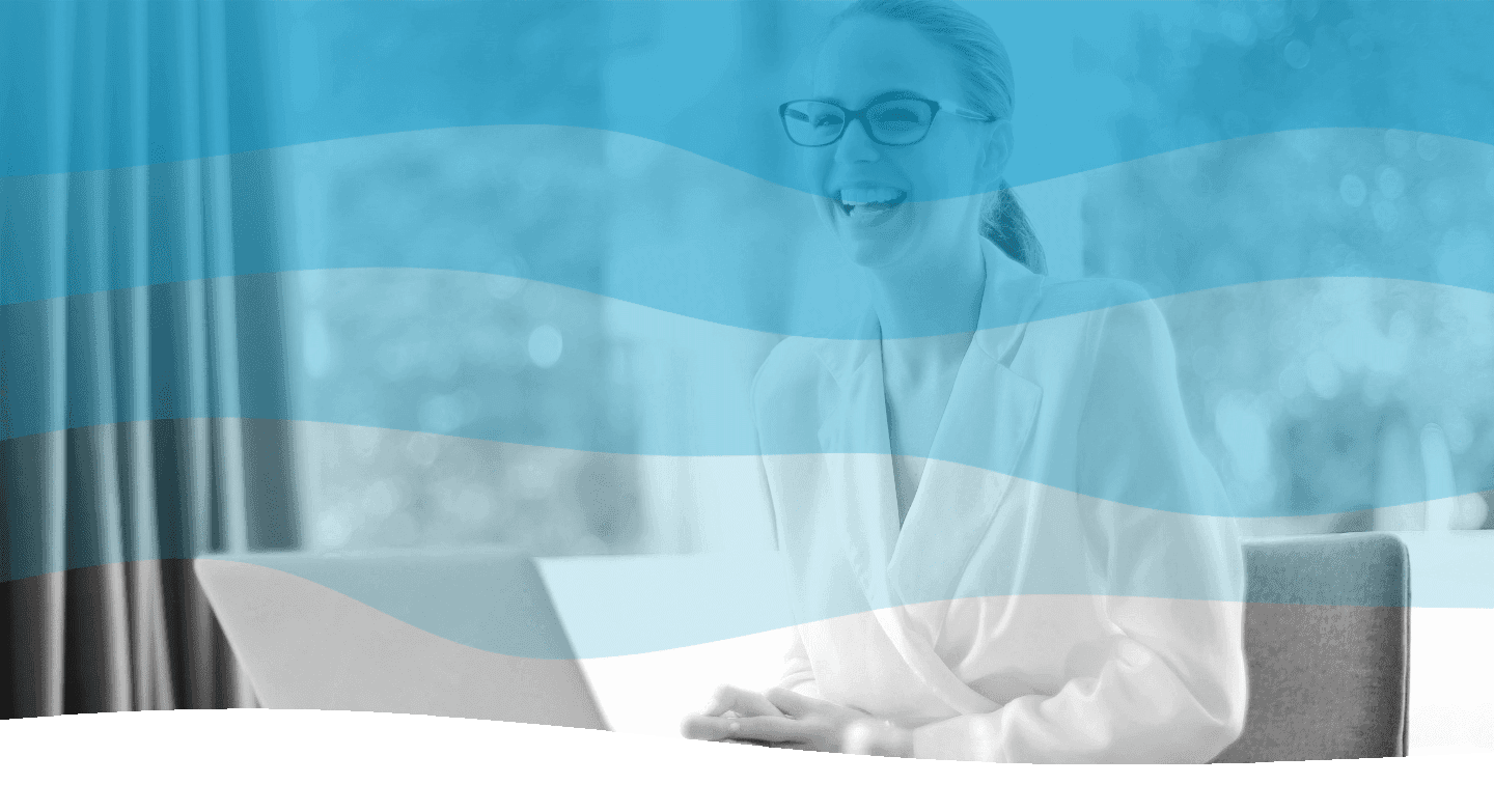 In a serene, well-lit office environment, a person in a professional suit is smiling and working at a laptop, with a filtered blue overlay enhancing the image's modern aesthetic.