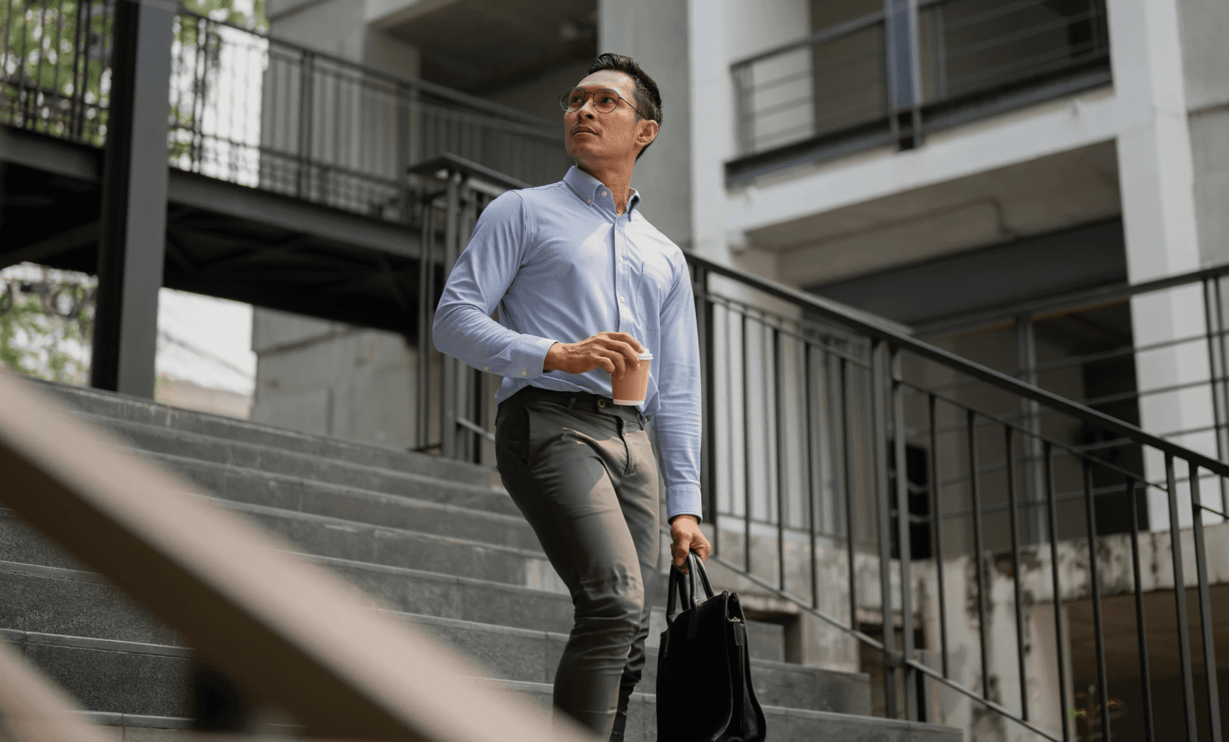 Business professional walking outside an office building during a workday.