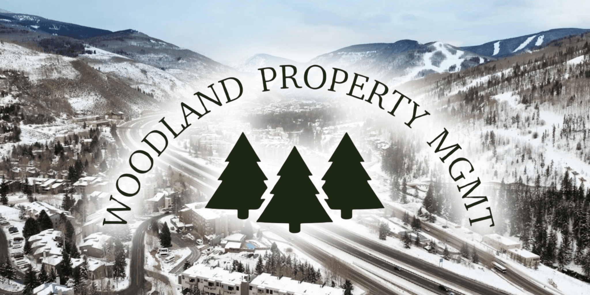 Woodland Property Mgmt logo over snowy mountain town and highway aerial view.