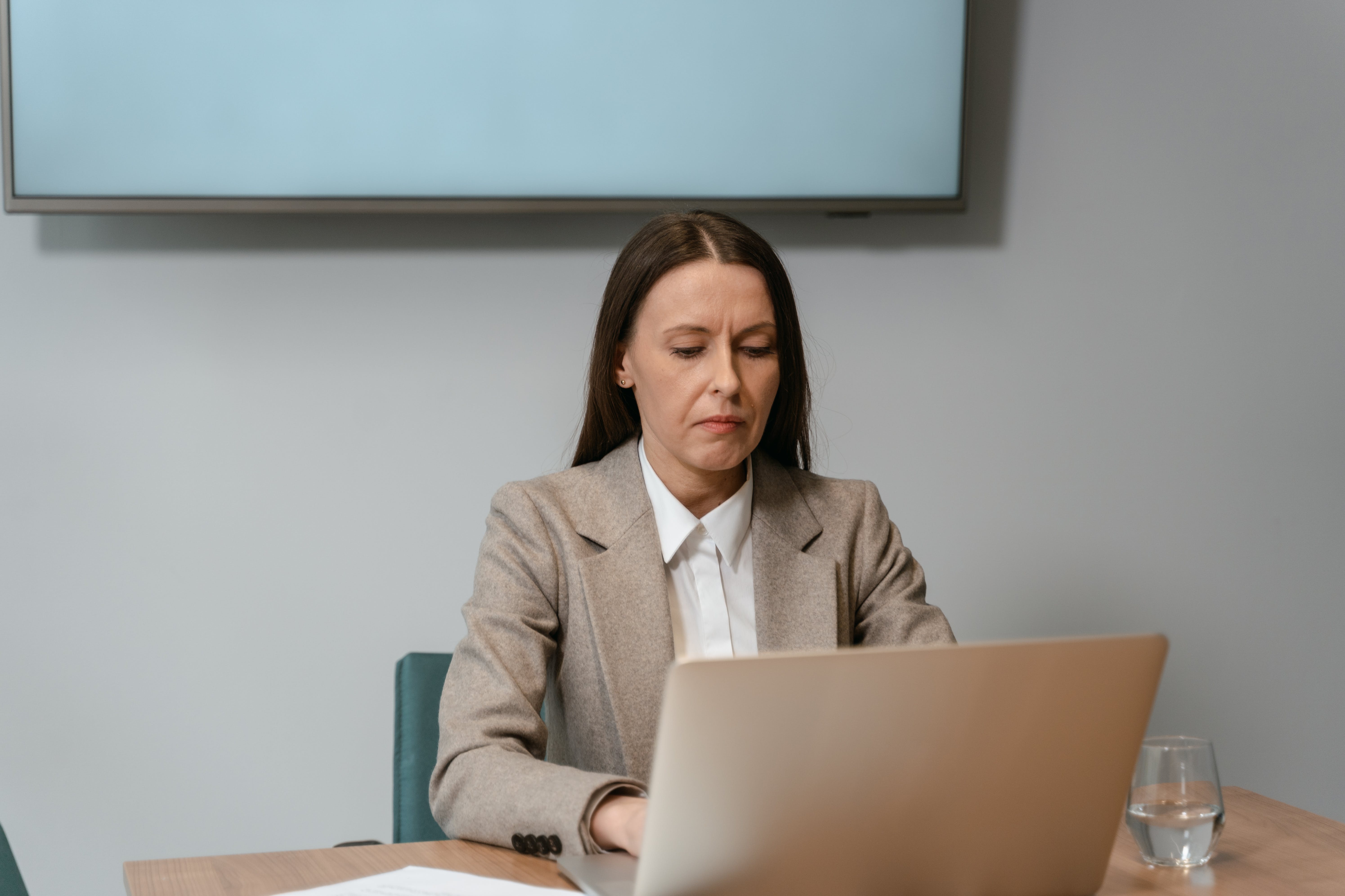 Woman working on her laptop researching about cold email legalities