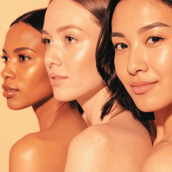 A group of 3 woman with different skin tones with glowing skin