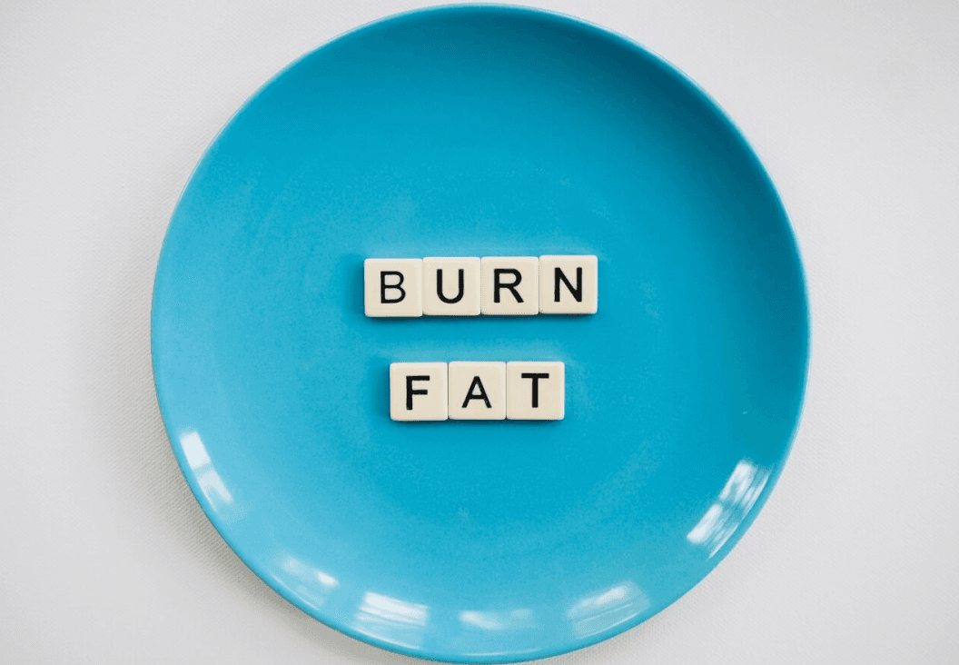 plate with words burn fat representing belly fat loss strategies for men”