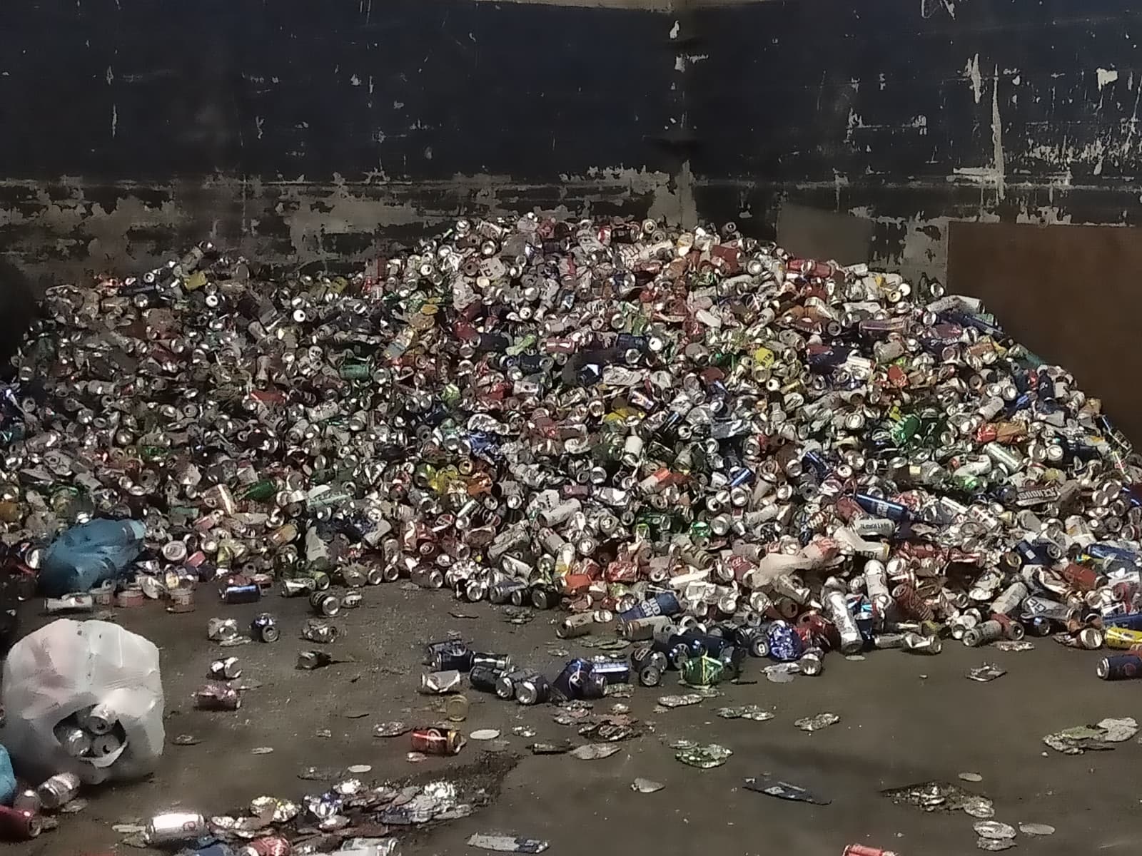 a group of cans and cans sitting on the side of a road