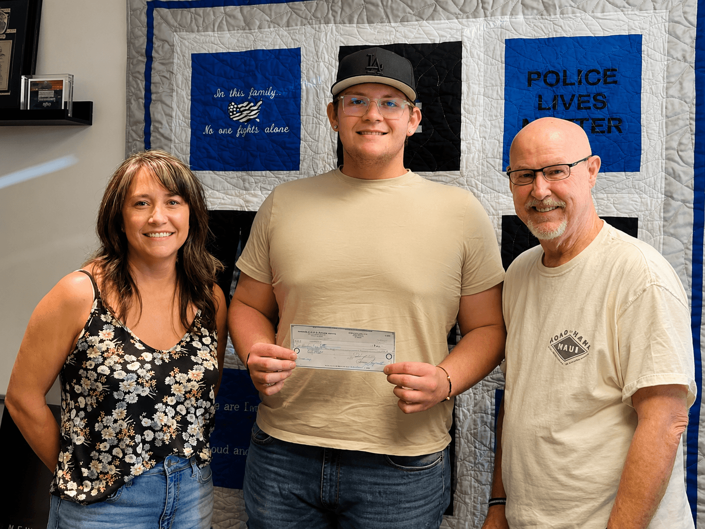 Scholarship recipient receiving check from board members