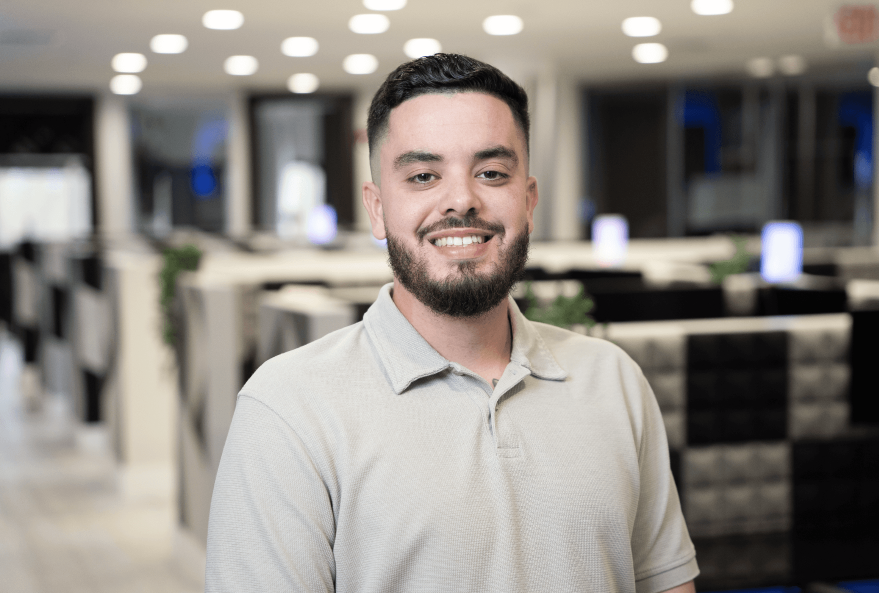 A woman stands in an office, with social media icons emerging from her laptop, symbolizing digital connectivity and engagement.