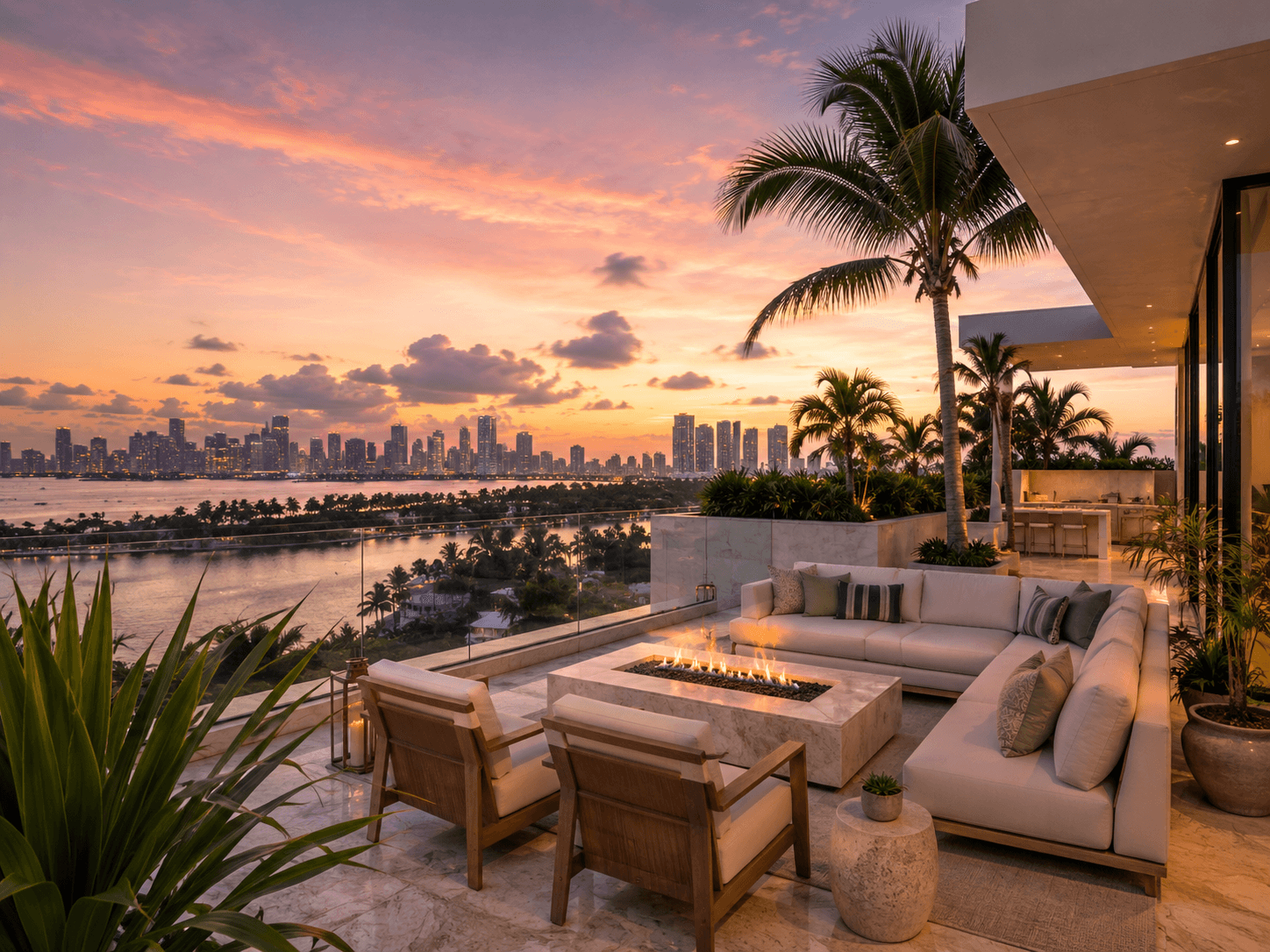 Rooftop terrace in Miami at sunset with outdoor lounge seating, fire pit, palm trees, and skyline views.